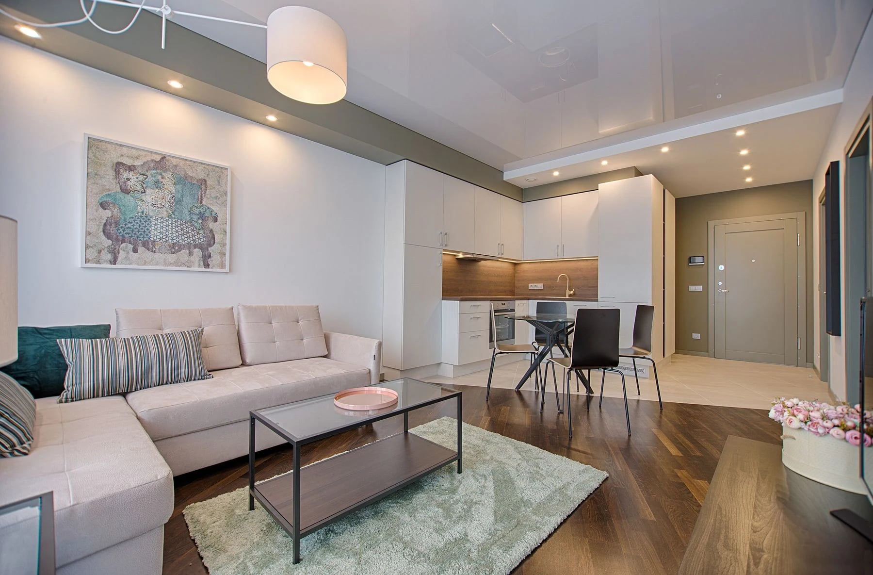 Modern living room featuring chic furniture, stylish decor, and a minimalist kitchen. Reference photograph for Nocturne House.