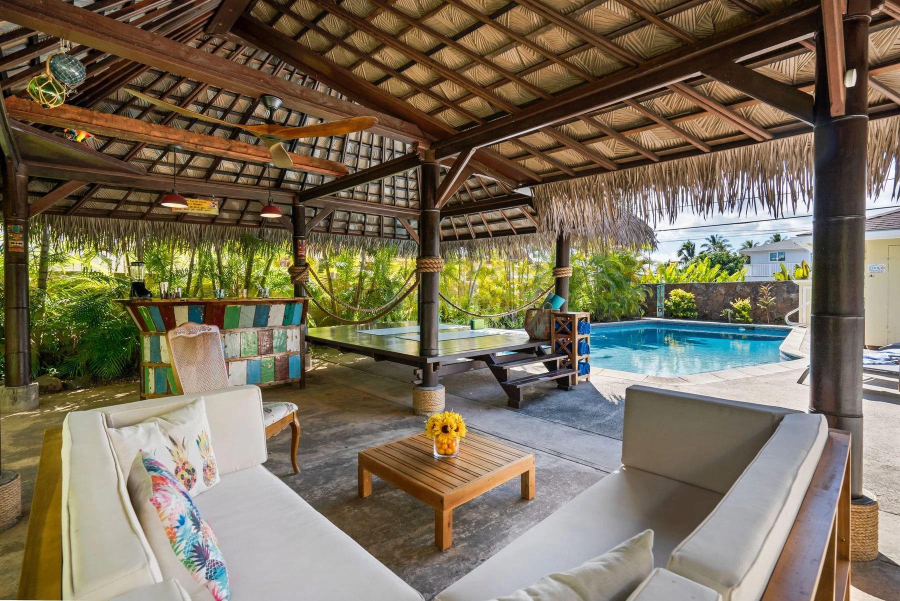 Tropical outdoor patio featuring a cabana, seating area, and swimming pool, perfect for luxury relaxation. Reference photograph for The Avara Villa.