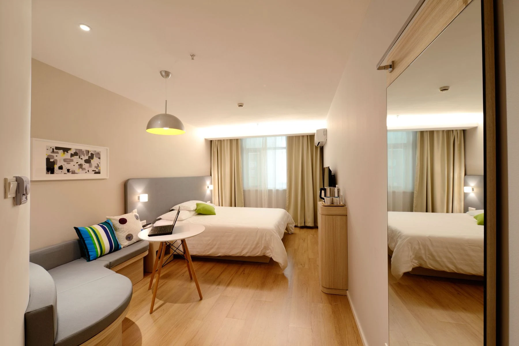 Modern hotel room featuring cozy decor and neutral tones with natural light. Reference photograph for The Avara Villa.