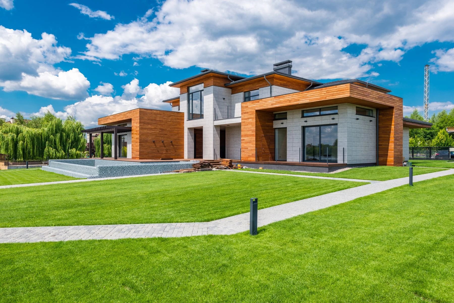 Contemporary villa with large green lawn and clear blue sky. Reference photograph for Terra Courtyard.