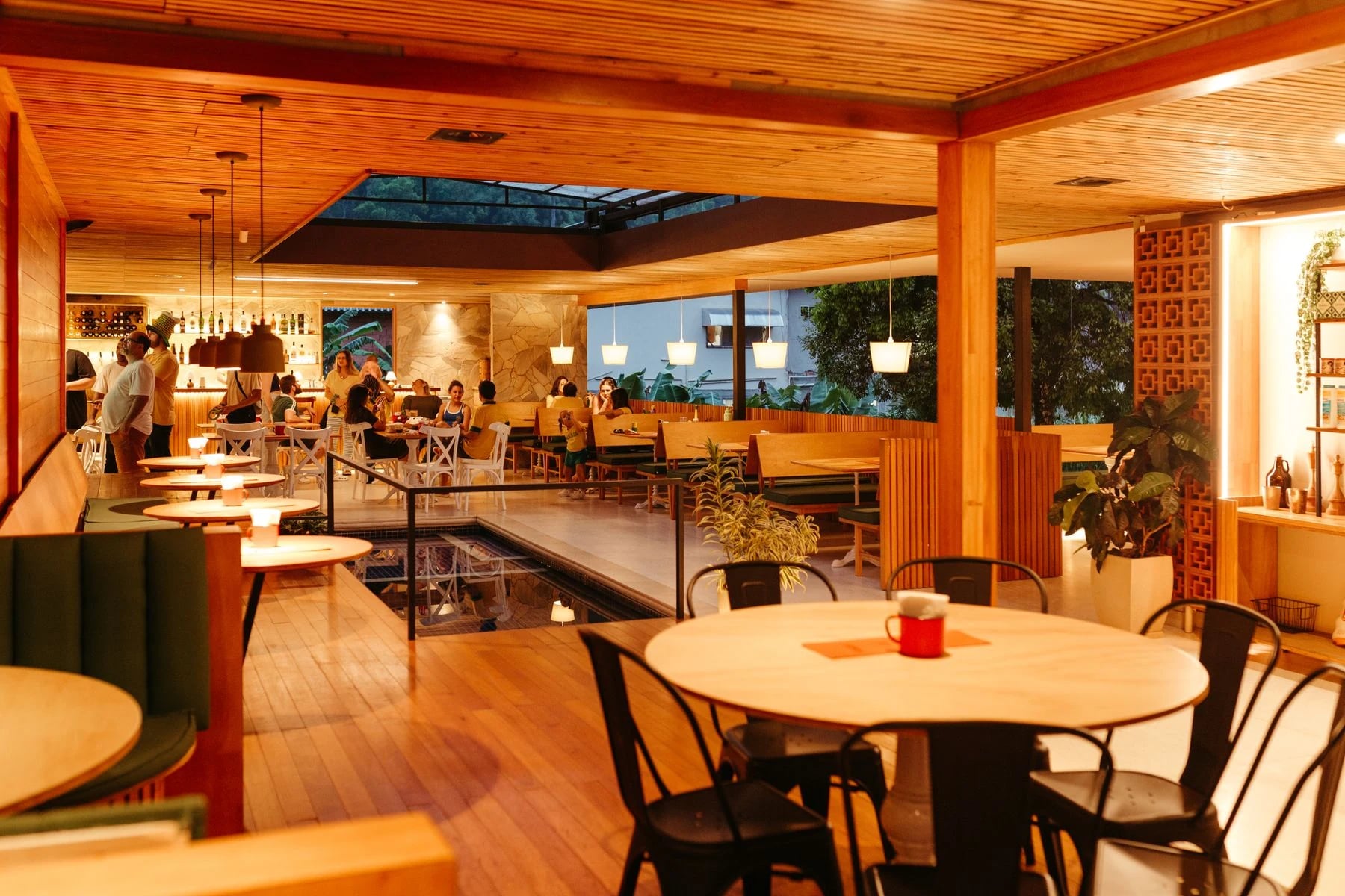 Warm and inviting restaurant interior with wooden decor and ambient lighting. Reference photograph for Forme Workspace.