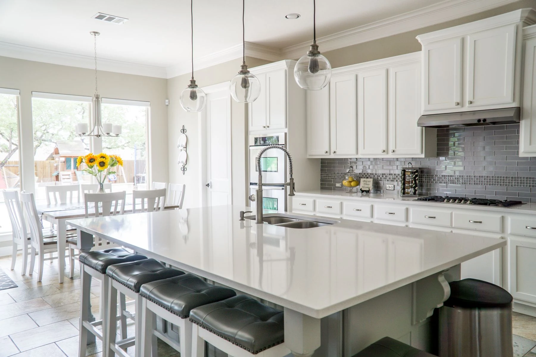 Modern kitchen with white cabinets and island in natural light. Reference photograph for Atelier Sora.