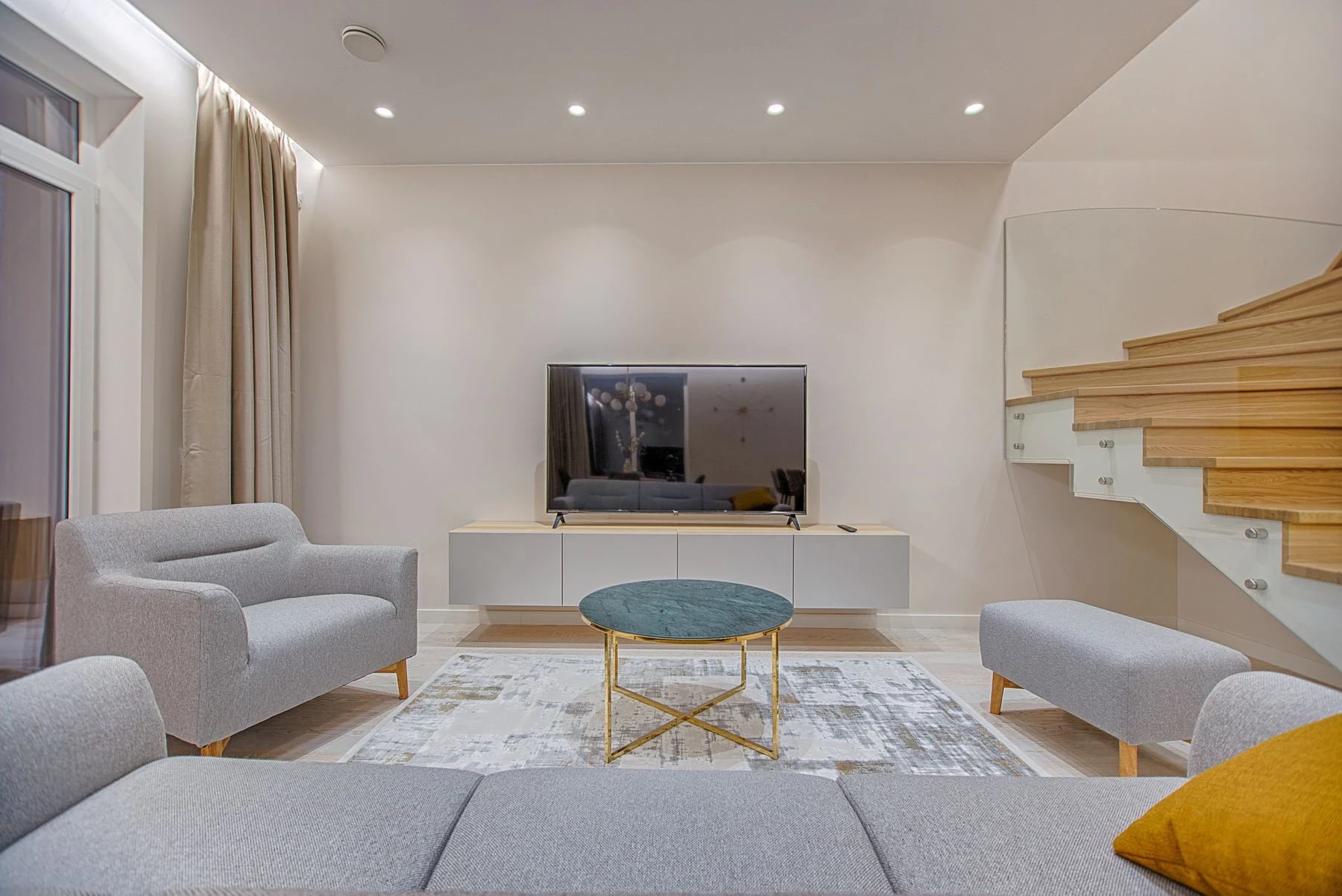 Stylish minimalist living room with modern furniture and warm lighting. Reference photograph for Nocturne House.