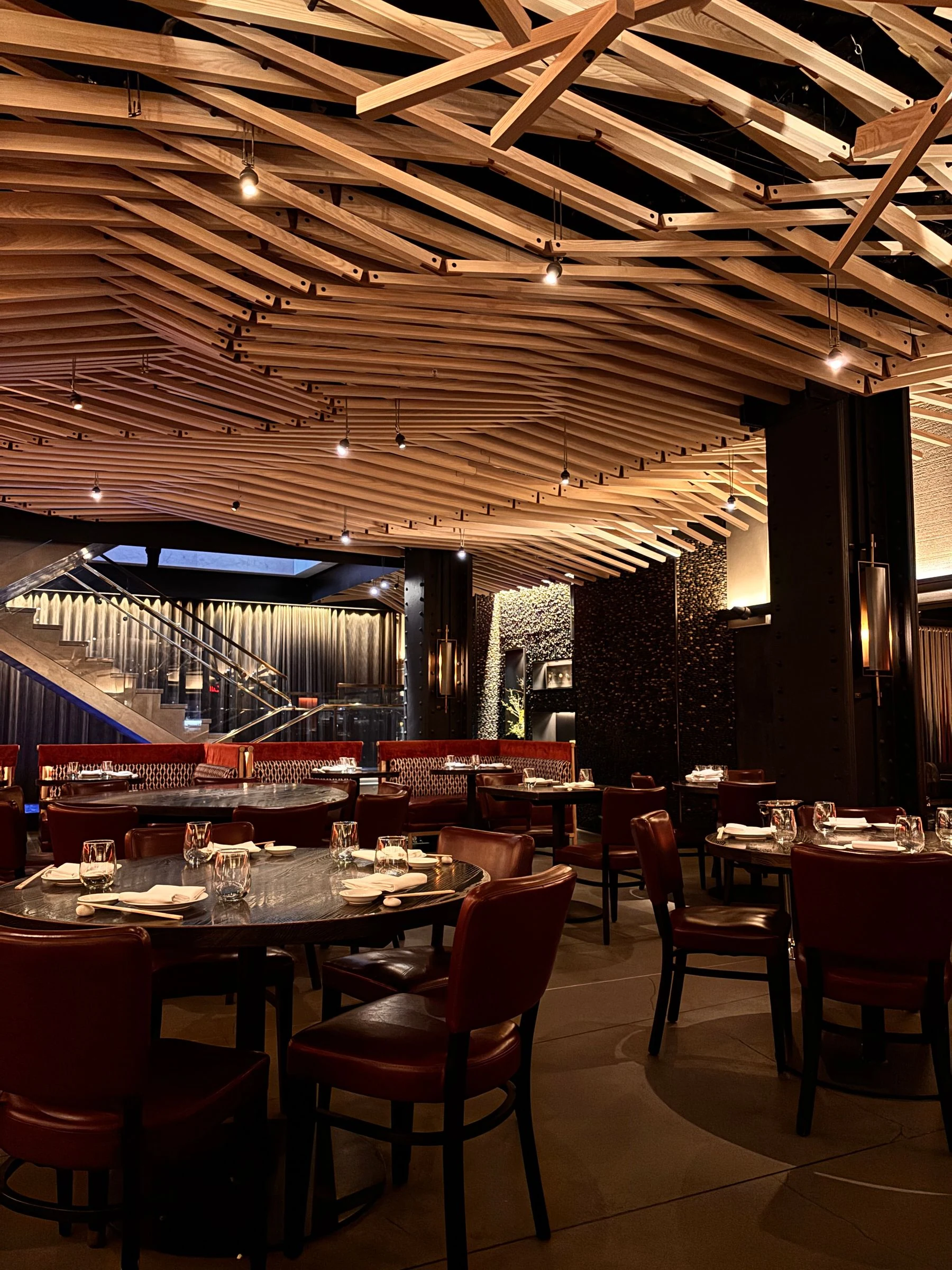 Restaurant interior featuring wooden ceiling and red leather seating. Reference photograph for Forme Workspace.